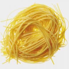 Fresh homemade tagliolini made with a chitarra pasta cutter at a